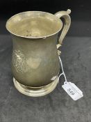 Hallmarked Silver: Georgian tankard of plain baluster form, scrolled handle on a stepped foot.