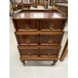 20th cent. Mahogany chest of three drawers taking the form of a step commode. 19ins.