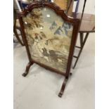 20th cent. Woolwork fire screen in ornate rosewood frame.