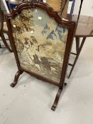 20th cent. Woolwork fire screen in ornate rosewood frame.