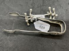 Hallmarked Silver: Pair of sugar tongs hallmarked Glasgow 1896, and a pair of carving rests (stands)