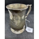 Hallmarked Silver: Georgian tankard of plain baluster form, scrolled handle on a stepped foot.