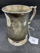 Hallmarked Silver: Georgian tankard of plain baluster form, scrolled handle on a stepped foot.