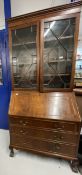 20th cent. Mahogany bureau bookcase with glazed top section, the whole supported on ball and claw