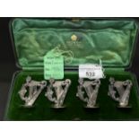 Hallmarked Silver (Irish): Set of four menu holders, harp design, with original invoice dated 2001