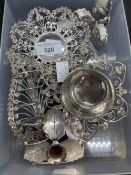 White metal tea strainer and stand, toast rack, all with leaf and scroll decoration,