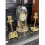 20th cent. Domed brass mantel clock 12ins. Plus a pair of 19th cent. Brass candlesticks. 9ins.