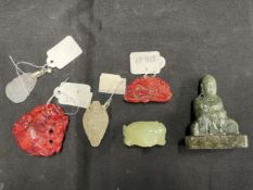 20th cent. Jade: Two Buddhas, three carved hard stone pendants, and hard stone net sake. (6)