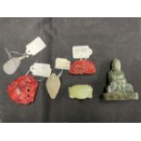 20th cent. Jade: Two Buddhas, three carved hard stone pendants, and hard stone net sake. (6)