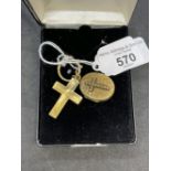 Yellow metal cross and oval locket. Both test as 9ct gold. Total weight 11.4g.