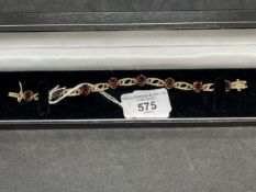 Hallmarked Jewellery: 9ct gold bracelet set with eight oval cut garnets, having a box and tongue