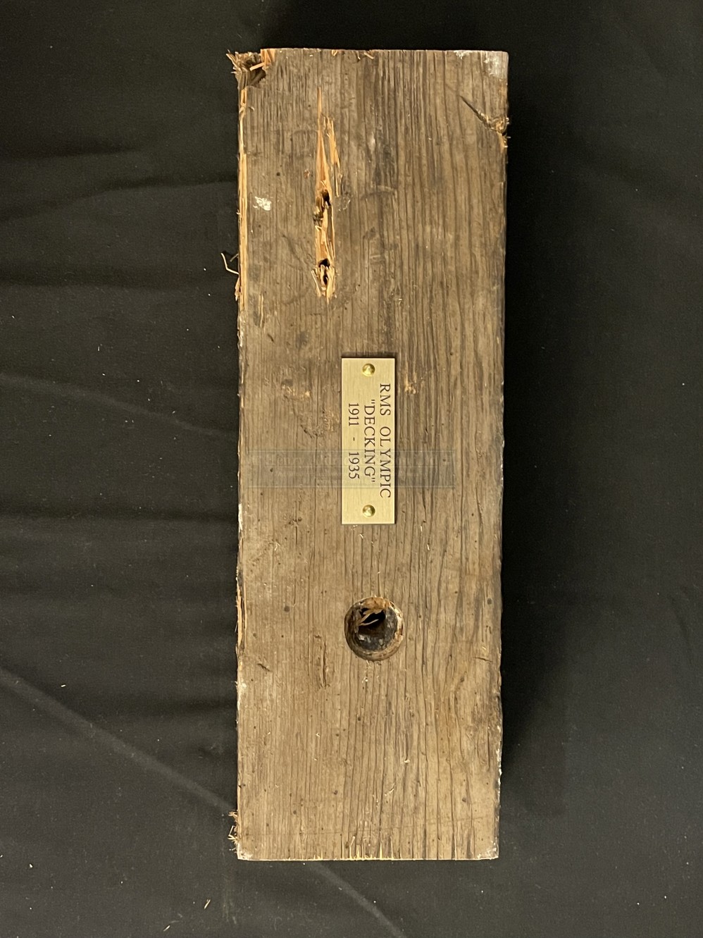 R.M.S. OLYMPIC: Pitch pine decking, approximately 14 inches long with plaque. Following the ships'