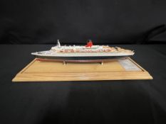 OCEAN LINER: Scale model of the Cunard Queen Elizabeth II by Maritime Replicas. Mounted on pine base