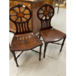 Late 18th cent. Mahogany hall chairs, the pierced shaped backs with central panels of satinwood, the