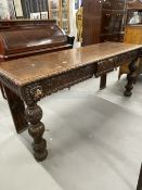 Late 19th/early 20th cent. Gothic carved oak serving table, the heavily carved frieze with central