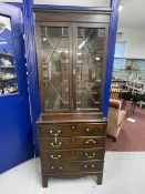 Late 19th cent. Slender mahogany glazed bookcase over four drawer chest, on bracket supports. 30ins.