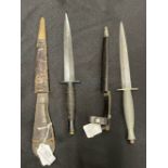 Edged Weapons: Commando Fairburn Sykes daggers in leather sheaths, one marked with cross key