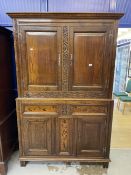 17th cent. Style oak cupboard with foliate carved stiles and inlaid bottom section, with stile feet.