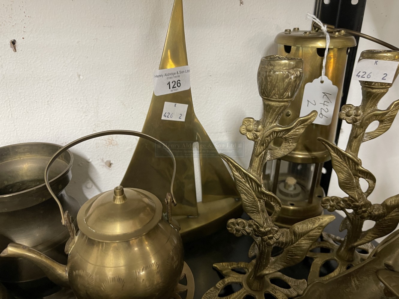 Brassware: Five graduated tankards, horse and carriage figure, two reproduction miners lamps, yacht,