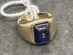 Yellow metal ring set with a cabouchon cut synthetic sapphire, stamped 14K, tests as 14ct gold.