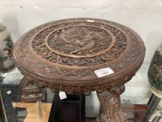 19th cent. Asian hardwood footstool heavily carved from top to bottom with stylised birds and