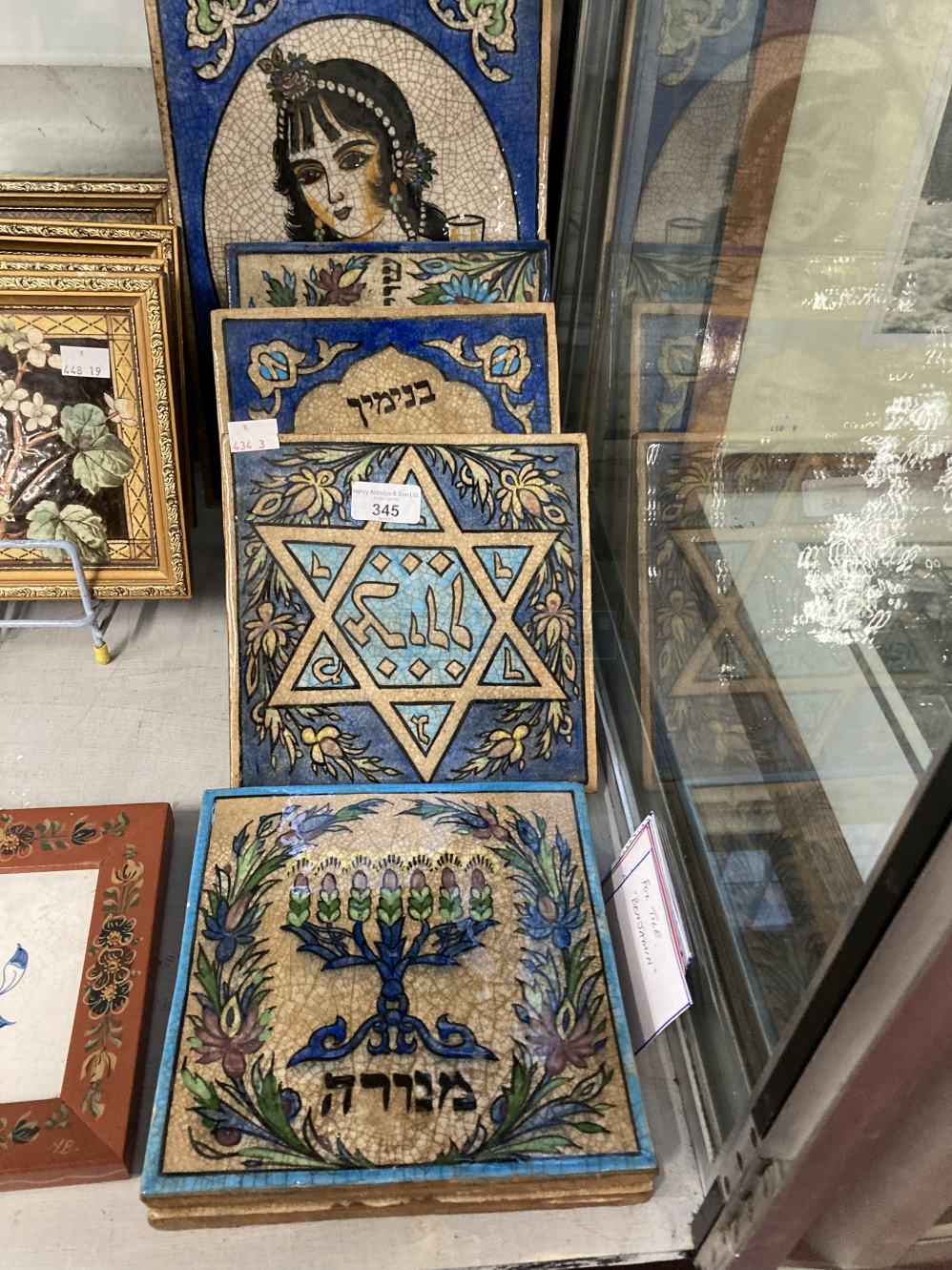 Decorative Objects: Five, plus one tiles, decorated with stylised images, with Hebrew text titled