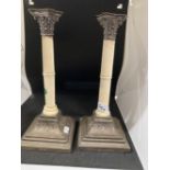 Silver: Pair of hallmarked silver and ivory desk candlesticks, the Corinthian capitols resting on