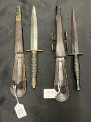 Edged Weapons: Commando Fairburn Sykes daggers in leather sheaths. 12ins. (2)