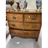 Early 19th cent. Mahogany two over two serpentine chest of drawers with brass furniture on bracket