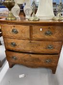 Early 19th cent. Mahogany two over two serpentine chest of drawers with brass furniture on bracket