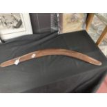 Tribal: Large Australian hardwood fighting boomerang with primitive carved decoration. 33ins.