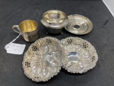 White metal pair of pierced and embossed dishes, a white gilt metal miniature cup and saucer (French
