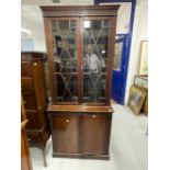 Early 20th cent. Mahogany two part bookcase, the thirteen pane glazed doors above two blind doors on