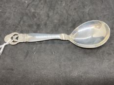 Scandinavian silver fruit spoon with pierced handle depicting a pair of dolphins with the name '