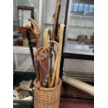 Walking Sticks: 20th cent. Wicker basket cane/umbrella stand with a selection of eight canes