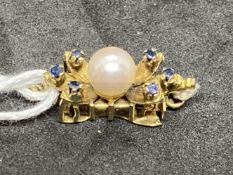 Yellow metal snap for a single ring set with a 6mm cultured pearl, with three small sapphires either