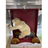 Toys: Modern Steiff limited edition museum collection teddy on a hand cart. 10ins.