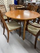 20th cent. Teak G plan circular dining table 44ins. Dia. Plus two slat back carvers and four