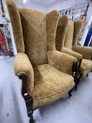 Early 20th cent. Upholstered wingback armchairs on shaped legs and castors, a pair. 50ins. x