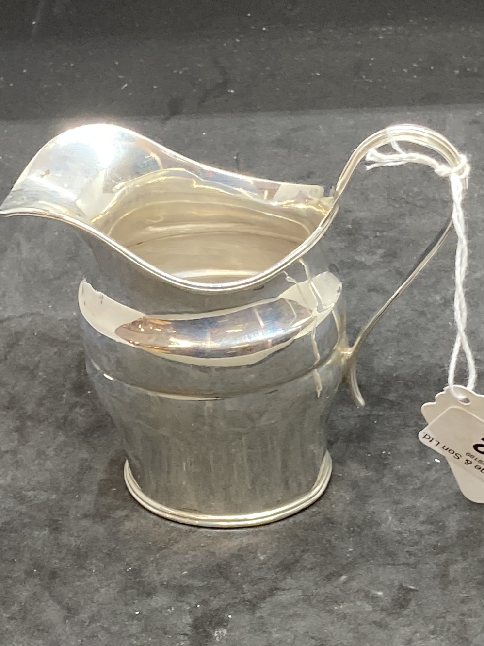Hallmarked Silver: Cream jug, reed pattern handle, hallmarked Edinburgh. Weight 3.8oz.