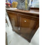 Early 20th cent. Mahogany two door cupboard on bracket supports with later internal additions.
