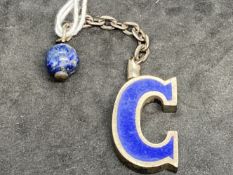 Hallmarked Silver: Gucci keyring in the form of a blue enamelled letter G with a lapis lazuli bead