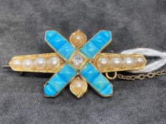 Yellow metal late Victorian bar brooch set with nine half pearls, at the centre is a cross set