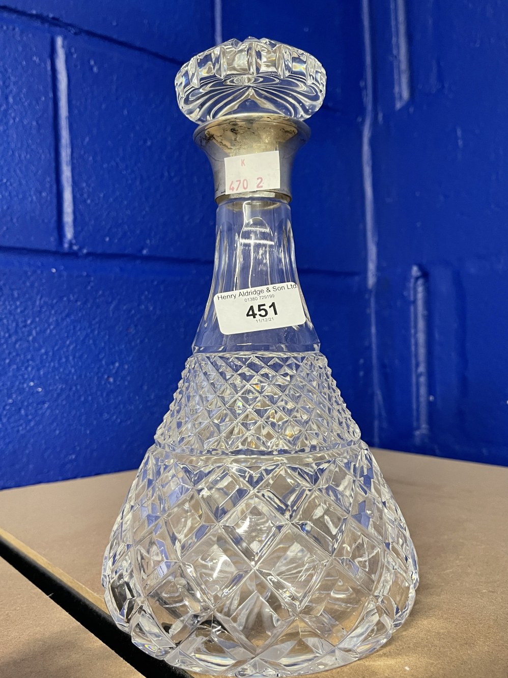 20th cent. Cut glass decanter with silver hallmarked collar. 10½ins.