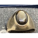 Yellow metal signet ring set with a cabouchon cut hematite. Stamped 18K, tests as 18ct gold.