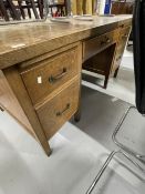 20th cent. Oak five drawer desk with two brushing slides on square legs terminating with brass caps,