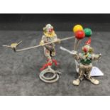 20th cent. White metal and enamel clowns, one with balloons and one walking the tightrope, most