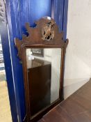 Early 19th cent. Mahogany mirror, shaped top with carved gilded ha ha bird and shaped bottom with