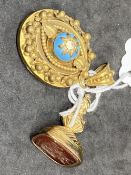 Yellow metal fob set with a carved cornelian, tests as 18ct gold. Weight 11.2g. Plus a 19th cent.