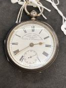 Kendal and Dent open faced key wind silver pocket watch, white dial, black Roman numerals, second